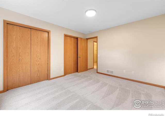 3822 W 11th St Unit 35, Greeley, CO 80634 - unfurnished bedroom with two closets and carpet