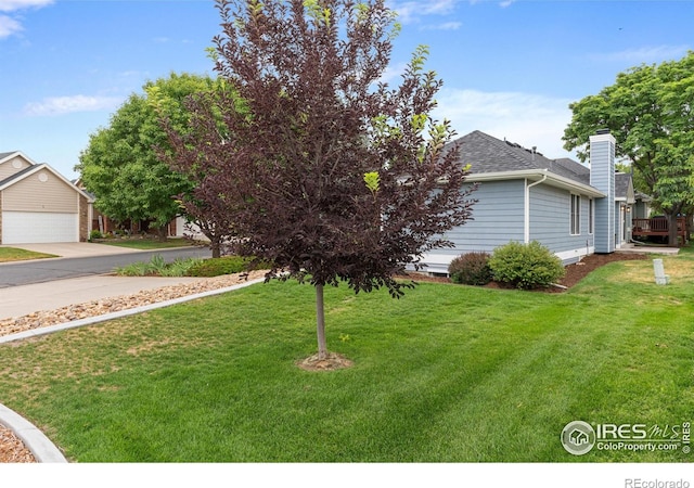 3822 W 11th St Unit 35, Greeley, CO 80634 - view of green lawn with a garage and driveway