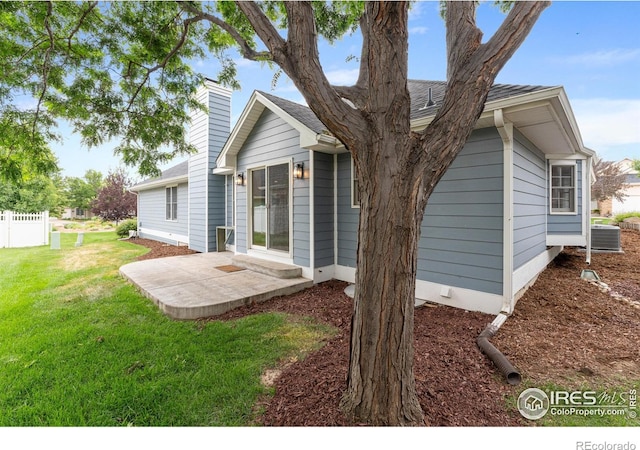 3822 W 11th St Unit 35, Greeley, CO 80634 - rear view of house featuring a patio area, a chimney, and roof with shingles
