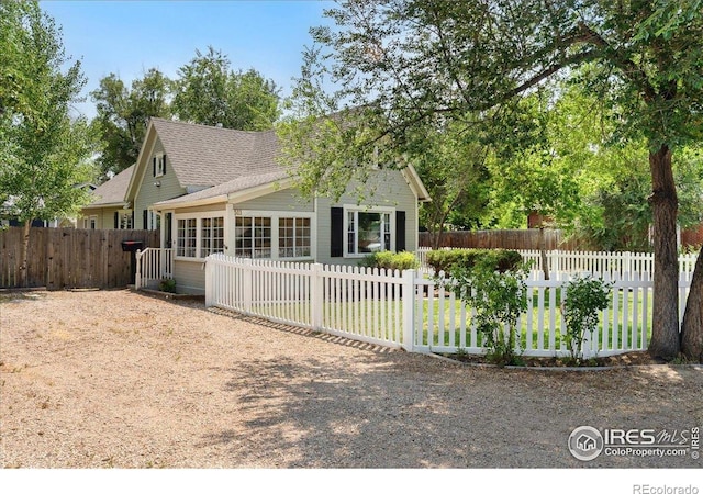 511 E Prospect Rd, Fort Collins, CO 80525 - view of front of property featuring a fenced front yard, roof with shingles, and a sunroom