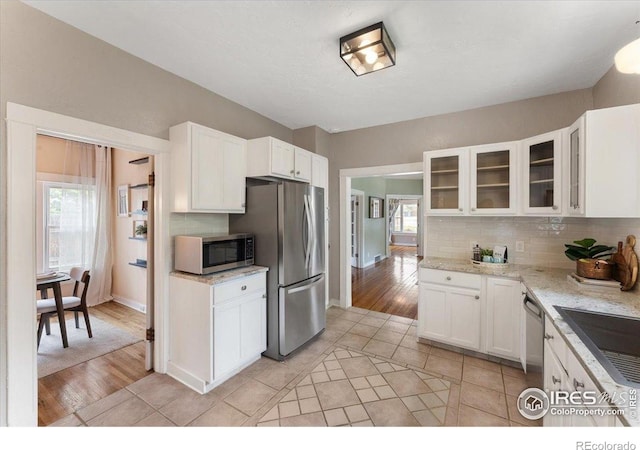 511 E Prospect Rd, Fort Collins, CO 80525 - kitchen featuring tasteful backsplash, white cabinetry, and appliances with stainless steel finishes