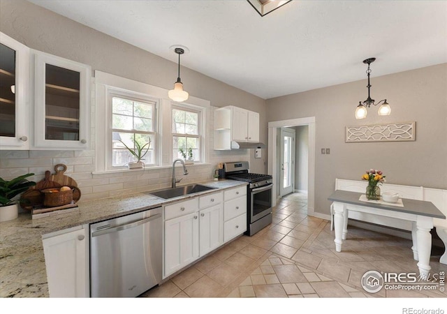 511 E Prospect Rd, Fort Collins, CO 80525 - kitchen featuring backsplash, appliances with stainless steel finishes, white cabinets, light tile patterned floors, and glass insert cabinets