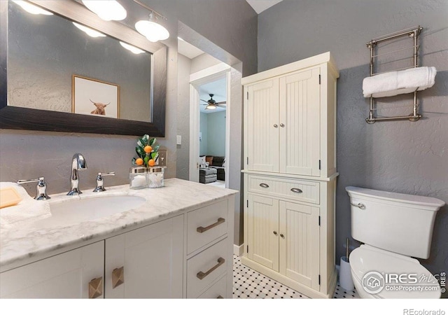 511 E Prospect Rd, Fort Collins, CO 80525 - bathroom featuring vanity, a ceiling fan, and a textured wall