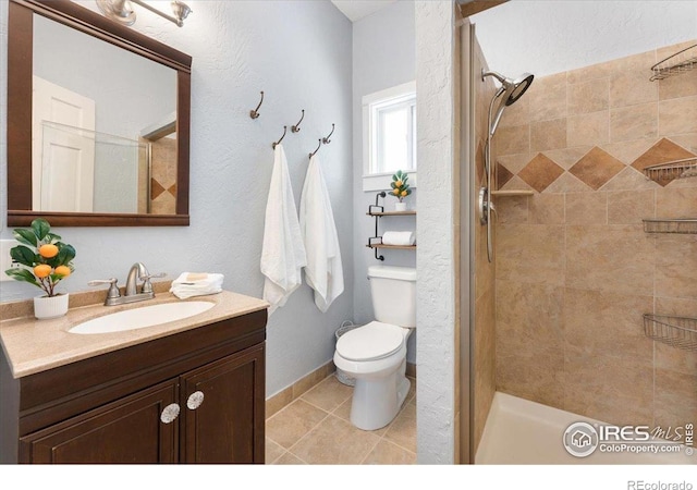 511 E Prospect Rd, Fort Collins, CO 80525 - bathroom featuring vanity, tiled shower, and tile patterned flooring
