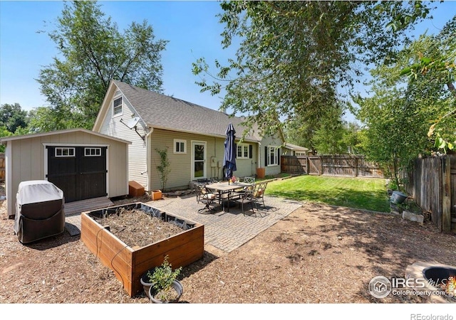 511 E Prospect Rd, Fort Collins, CO 80525 - rear view of property featuring a fenced backyard, a patio, a shed, a shingled roof, and a vegetable garden