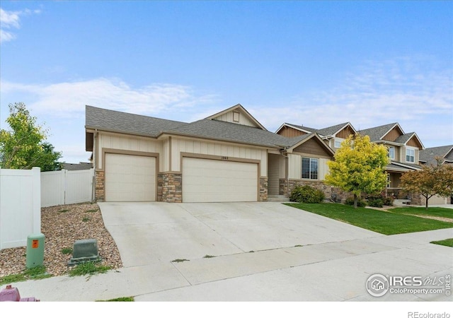 1062 Mt Columbia Dr, Severance, CO 80550 - craftsman-style home featuring a garage, stone siding, concrete driveway, and a shingled roof