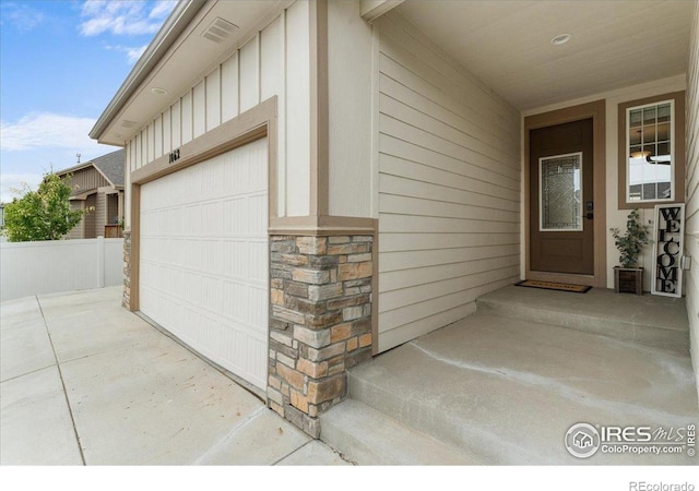 1062 Mt Columbia Dr, Severance, CO 80550 - view of exterior entry featuring a garage, stone siding, and board and batten siding