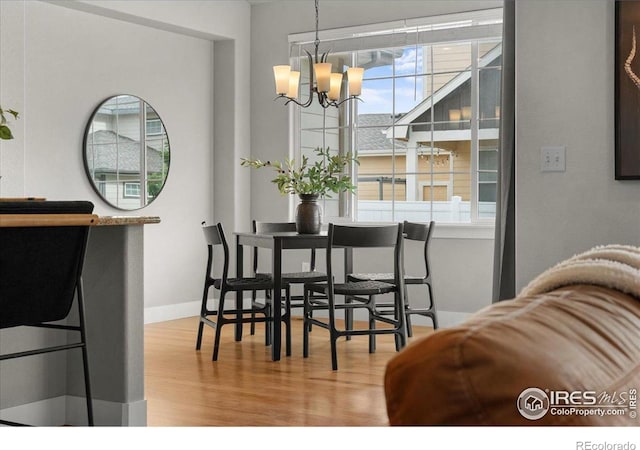 1062 Mt Columbia Dr, Severance, CO 80550 - dining area featuring plenty of natural light, wood finished floors, and a chandelier