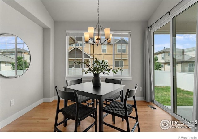 1062 Mt Columbia Dr, Severance, CO 80550 - dining room with plenty of natural light, a chandelier, and light wood-style floors