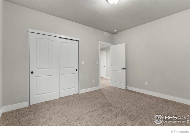 1062 Mt Columbia Dr, Severance, CO 80550 - unfurnished bedroom with carpet flooring, a closet, and a textured ceiling