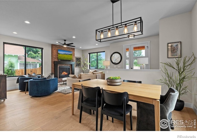 4306 Dixon St, Timnath, CO 80547 - dining room with wood finished floors, a fireplace, a ceiling fan, and recessed lighting