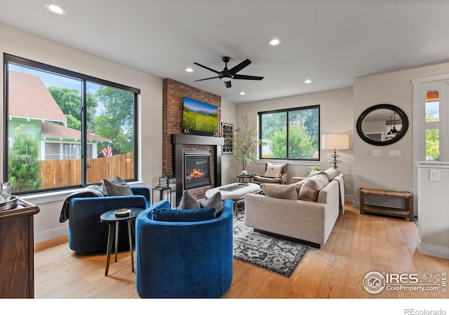 4306 Dixon St, Timnath, CO 80547 - living room with a fireplace, wood finished floors, a ceiling fan, and recessed lighting