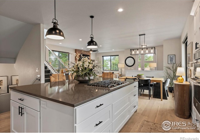4306 Dixon St, Timnath, CO 80547 - kitchen with dark countertops, light wood-type flooring, white cabinetry, decorative light fixtures, and recessed lighting