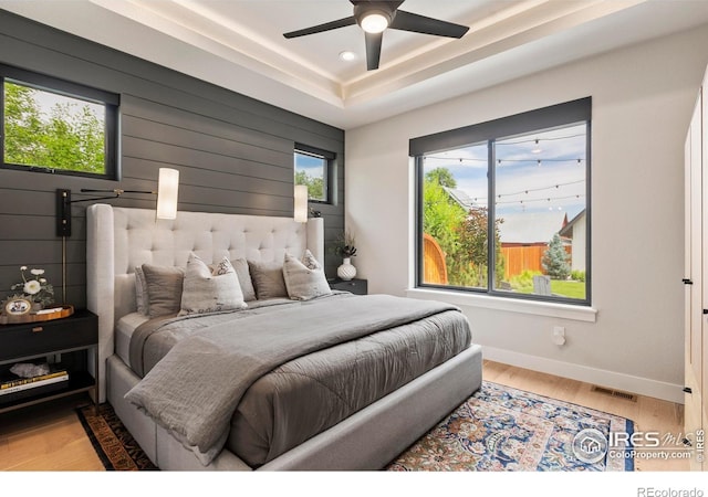 4306 Dixon St, Timnath, CO 80547 - bedroom with wood finished floors, recessed lighting, a tray ceiling, and ceiling fan