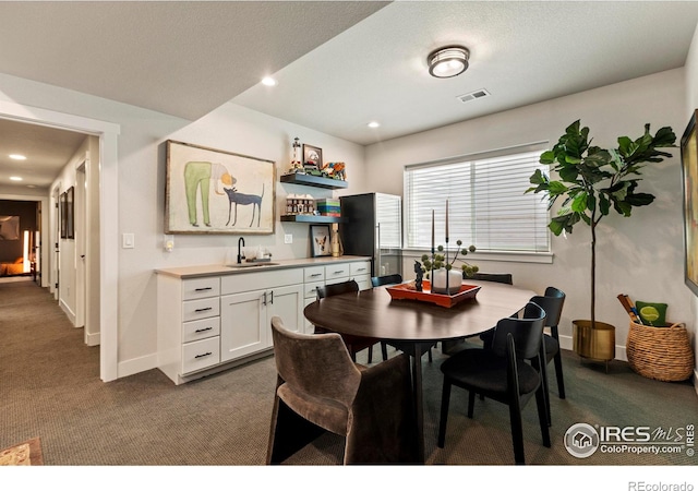 4306 Dixon St, Timnath, CO 80547 - dining room featuring dark colored carpet, wet bar, and recessed lighting