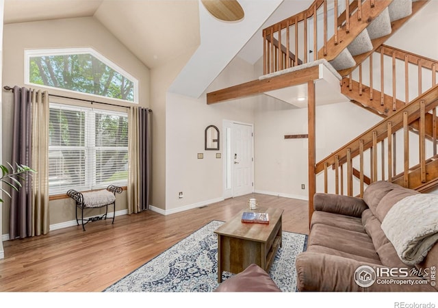 11417 King Way, Westminster, CO 80031 - living area featuring high vaulted ceiling, wood finished floors, and stairway
