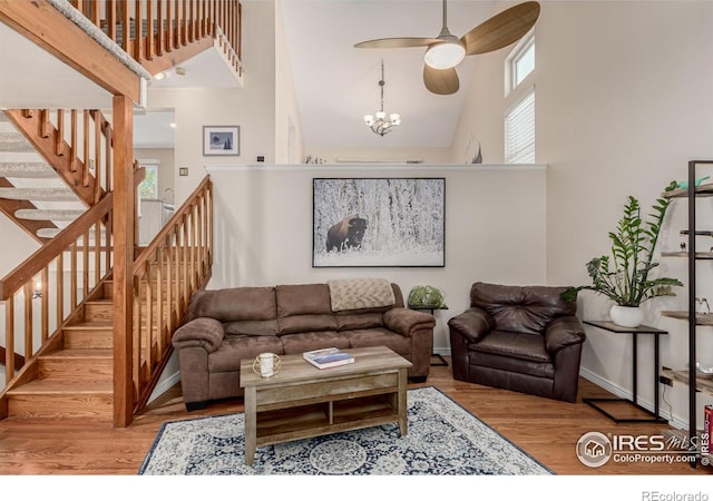 11417 King Way, Westminster, CO 80031 - living room with a high ceiling, wood finished floors, healthy amount of natural light, a ceiling fan, and stairway