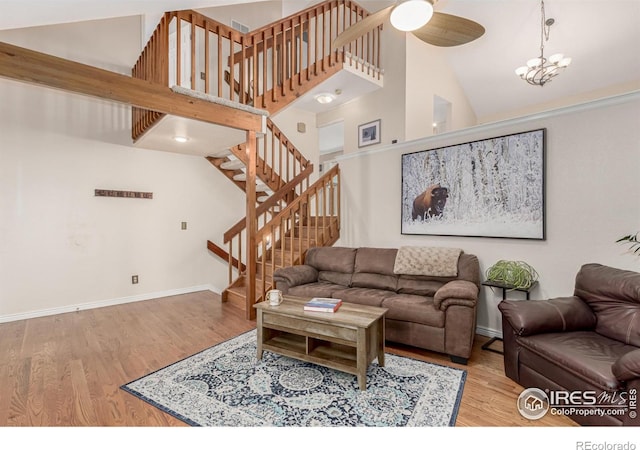 11417 King Way, Westminster, CO 80031 - living area with stairway, wood finished floors, a towering ceiling, and a ceiling fan
