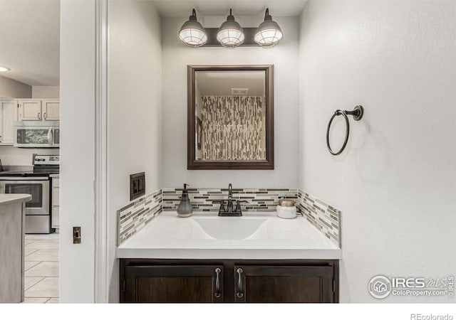 11417 King Way, Westminster, CO 80031 - bathroom with vanity, tile patterned flooring, and tasteful backsplash