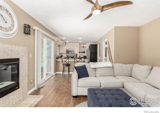 11417 King Way, Westminster, CO 80031 - living area featuring light wood-style floors, ceiling fan, recessed lighting, and a tiled fireplace