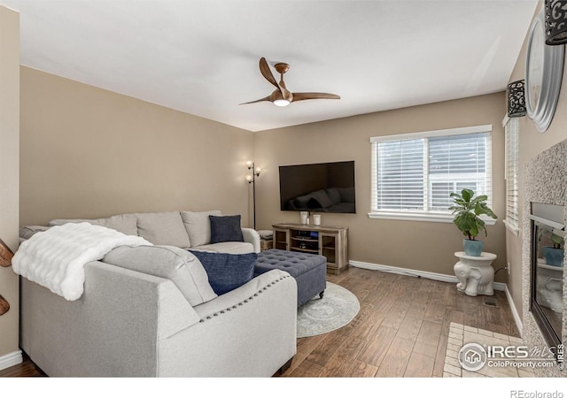 11417 King Way, Westminster, CO 80031 - living area featuring ceiling fan, wood finished floors, and a glass covered fireplace