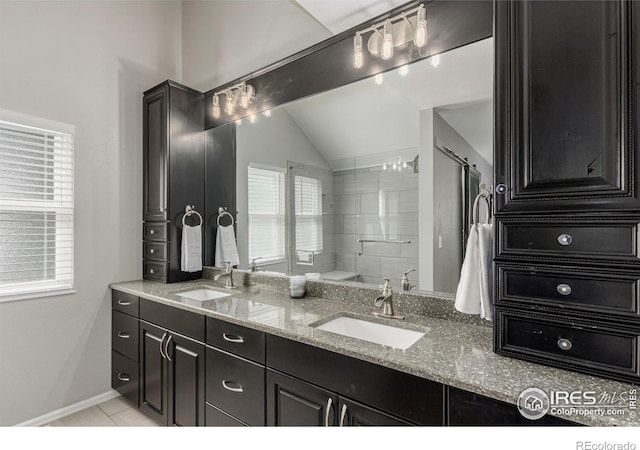 11417 King Way, Westminster, CO 80031 - bathroom featuring lofted ceiling, double vanity, tile patterned floors, and a shower