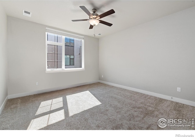 spare room featuring carpet flooring and ceiling fan