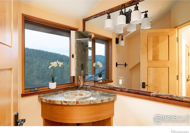 bathroom with vanity and vaulted ceiling