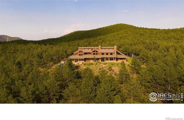 birds eye view of property featuring a mountain view