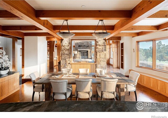 dining room featuring hardwood / wood-style flooring and beam ceiling