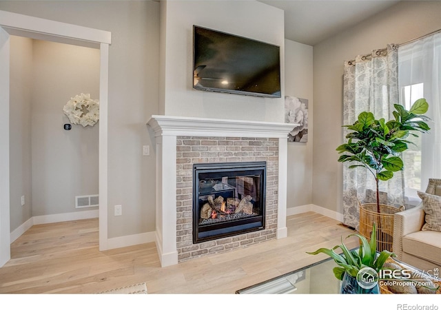 living room with a fireplace and light hardwood / wood-style floors