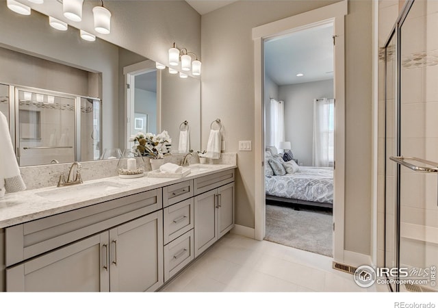 bathroom featuring vanity, tile patterned flooring, and a shower with door