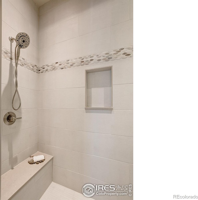 bathroom with a tile shower