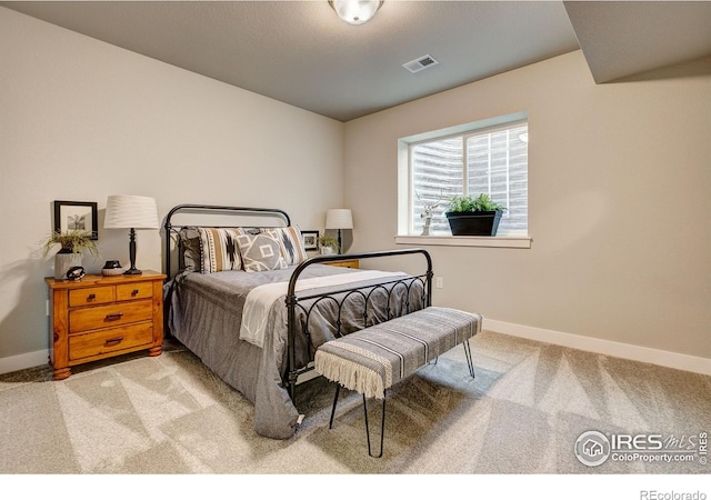 bedroom with light colored carpet