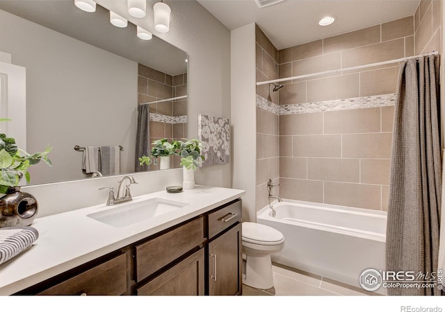 full bathroom with vanity, shower / tub combo, tile patterned floors, and toilet