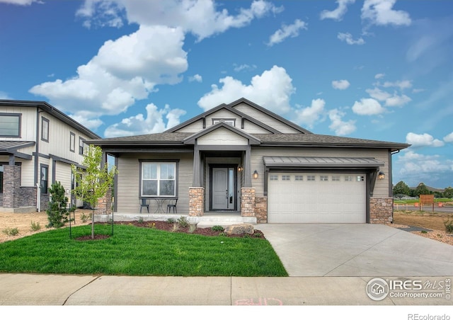 craftsman house with a garage and a front yard