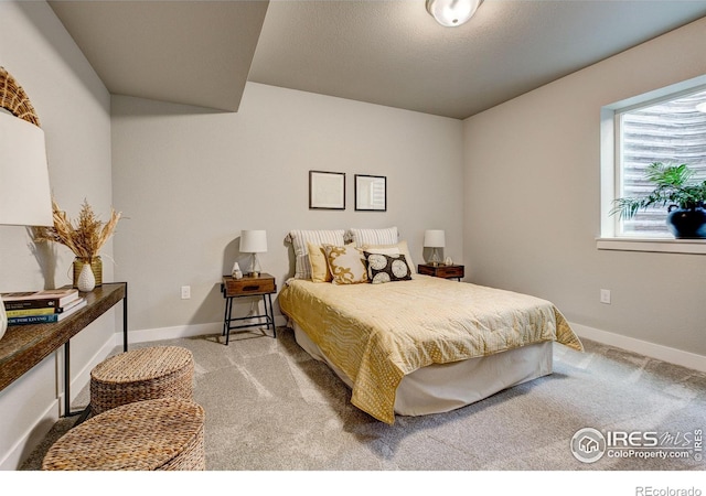 bedroom with light colored carpet