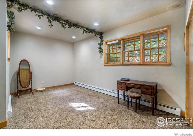 misc room with carpet flooring and a baseboard heating unit