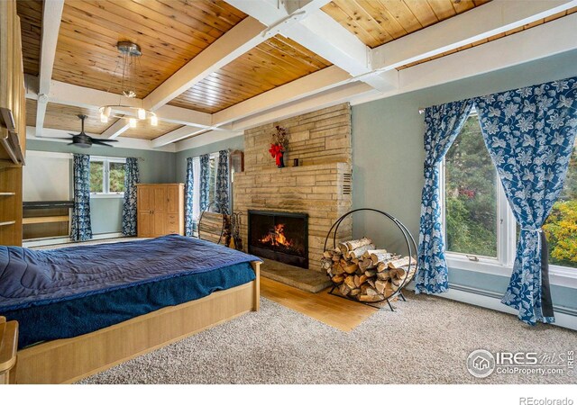 bedroom with multiple windows, beam ceiling, and hardwood / wood-style flooring