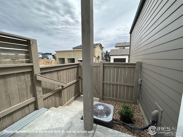 view of patio featuring cooling unit and a fenced backyard