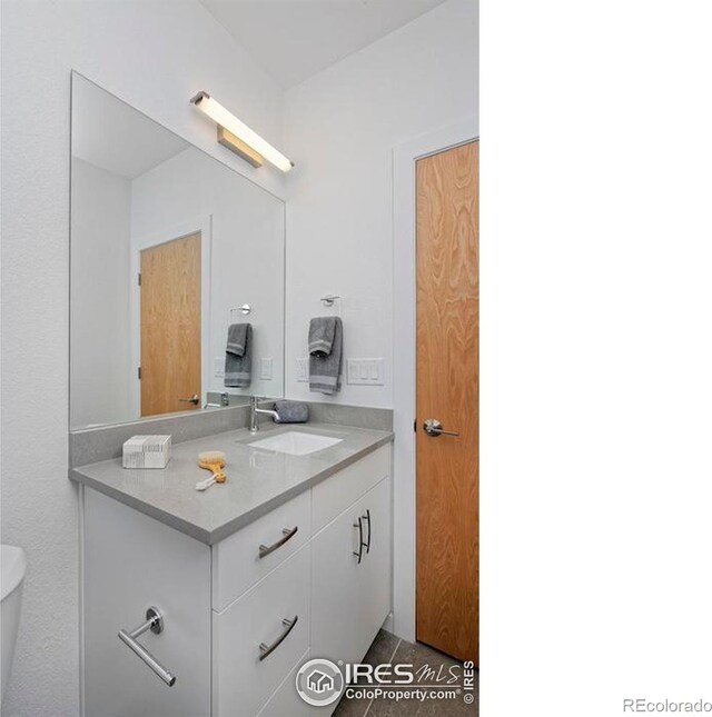 bathroom with toilet and vanity