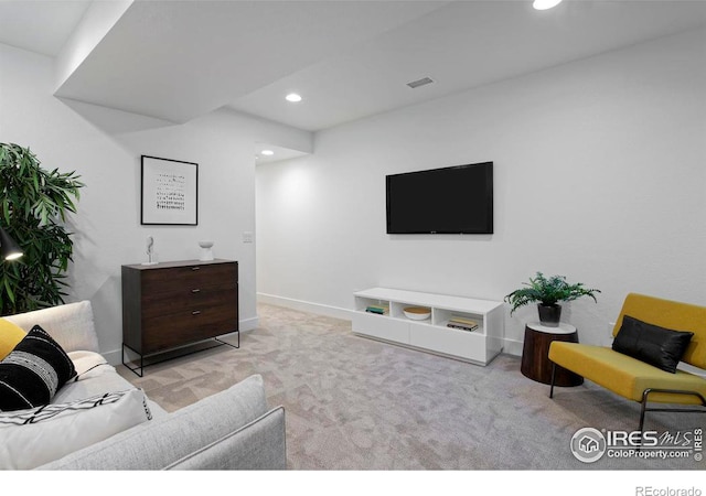 carpeted living room featuring recessed lighting, visible vents, and baseboards