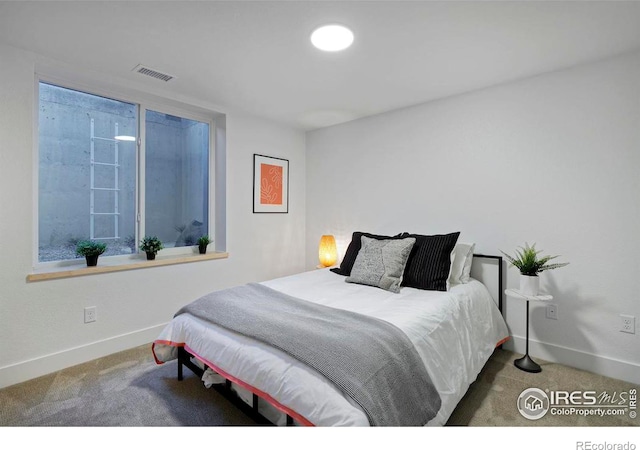 bedroom featuring visible vents, carpet flooring, and baseboards