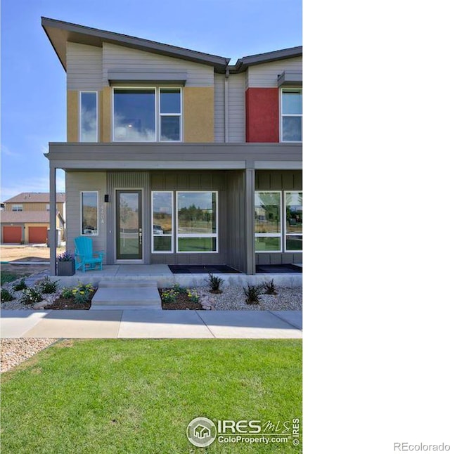 view of front of home with a front yard and board and batten siding