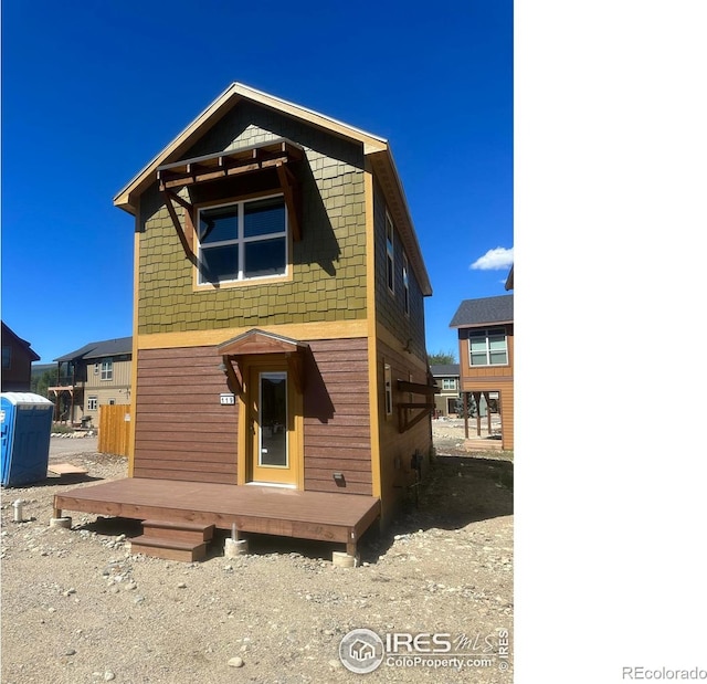 rear view of property featuring a deck