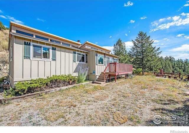 rear view of property featuring a deck