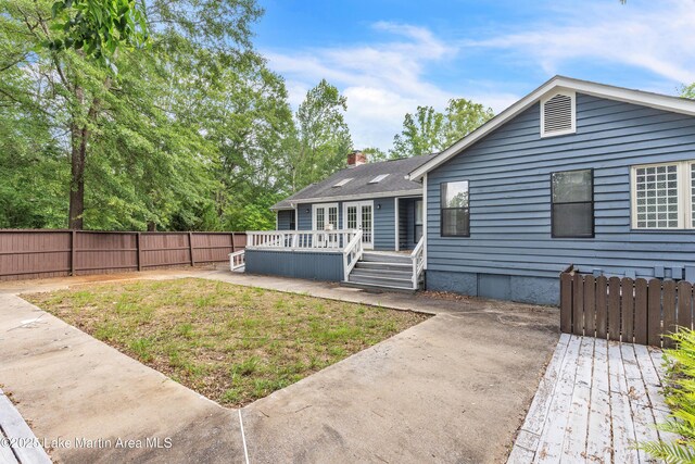 226 Auburn Dr, Alexander City, AL 35010 - back of property featuring a fenced backyard, a wooden deck, a chimney, a patio, and crawl space