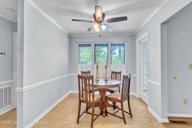 226 Auburn Dr, Alexander City, AL 35010 - dining space featuring a ceiling fan, light tile patterned flooring, a textured ceiling, and ornamental molding