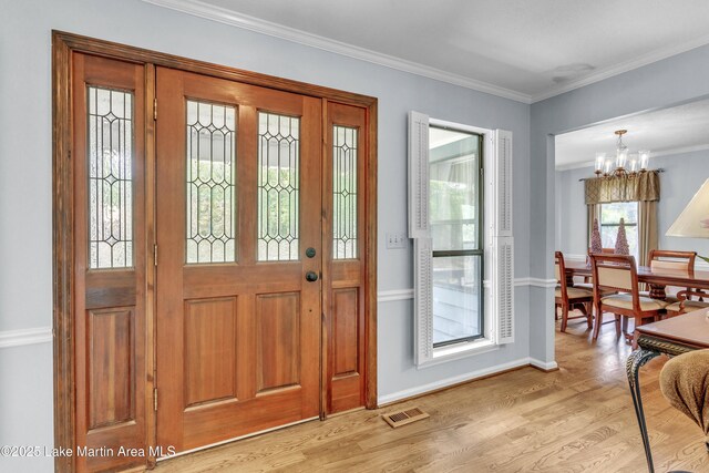 226 Auburn Dr, Alexander City, AL 35010 - entryway featuring a chandelier, light wood-type flooring, and ornamental molding