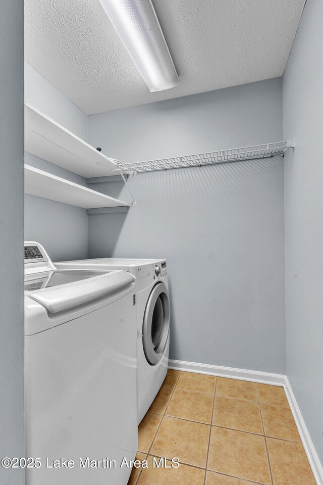 226 Auburn Dr, Alexander City, AL 35010 - laundry room featuring independent washer and dryer, light tile patterned flooring, and a textured ceiling